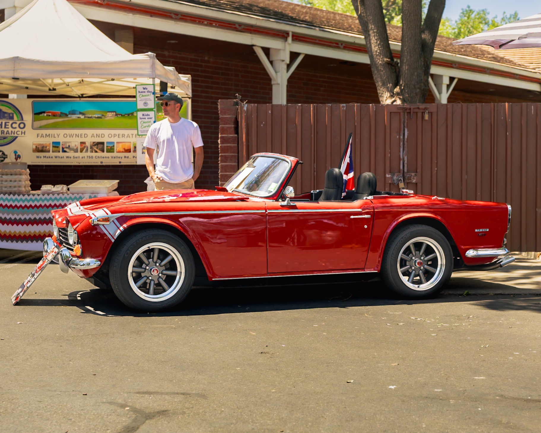 Red Triumph TR250 with Union Jack flag