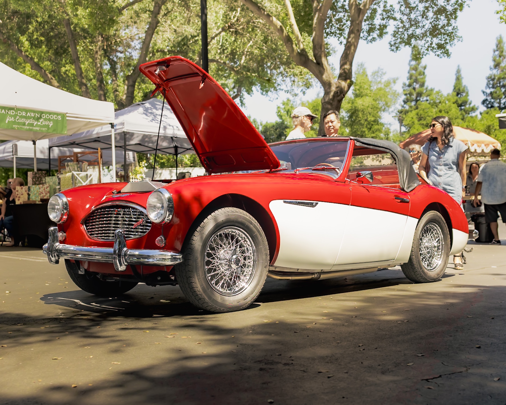 Red and white Austin-Healey with hood up