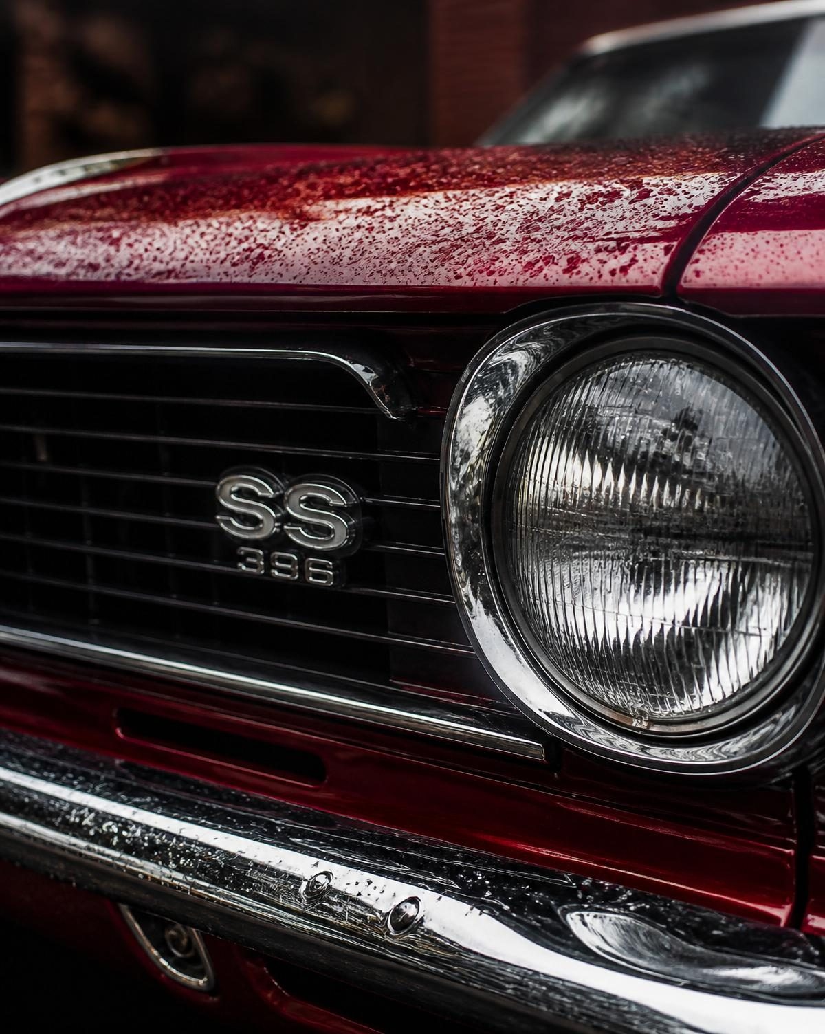 Chrome grille and headlight detail of a classic American muscle car